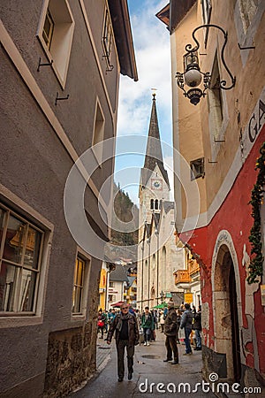 Hallstatt/Austria- December 26, 2019: Tourists on the streets of Hallstatt, a charming traditional village and a famous tourist Editorial Stock Photo