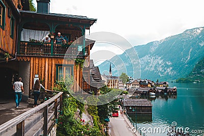 Hallstatt, Austria - June 15, 2019: elder people talking from the balcony with young couple Editorial Stock Photo
