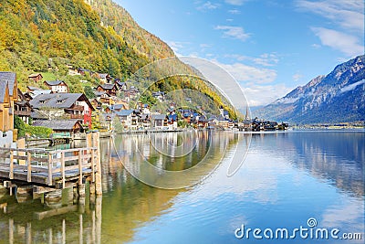 Hallstatt under blue sunny sky with reflections on smooth lake water Stock Photo