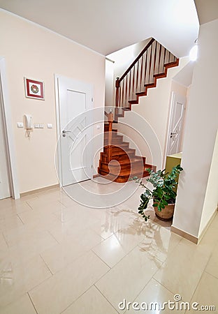 Hallway with wooden stairs to upper floors Stock Photo