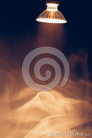 Halogen lamp with reflector, warm spotlight in smoke Stock Photo
