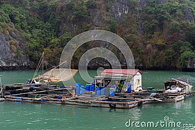 Halong Bay in mystical clouds. Traditional fishermens village in ther sea. Mystical atmoshpere in the world famous halong bay. t Stock Photo