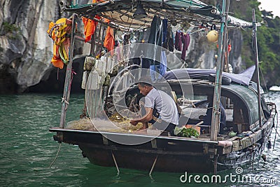 Halong bay traditional fishing boats, UNESCO world natural heritage, Vietnam. Tourist cruise ships sailing among limestone Editorial Stock Photo