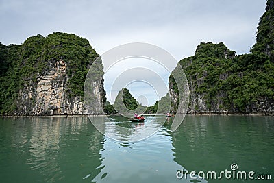 Halong bay in Vietnam, UNESCO World Heritage Site, with tourist rowing boats Editorial Stock Photo