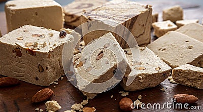 Halva almond nuts slices on wooden table background Stock Photo