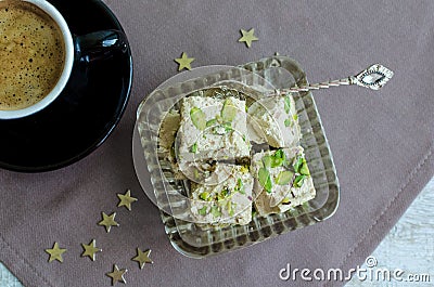 Halva pistachio and cup of coffee Stock Photo