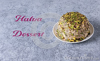 Halva with pistachios on gray background with pink text Stock Photo