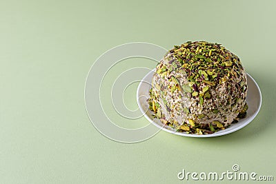 Halva with pistachios on green background with copy space Stock Photo