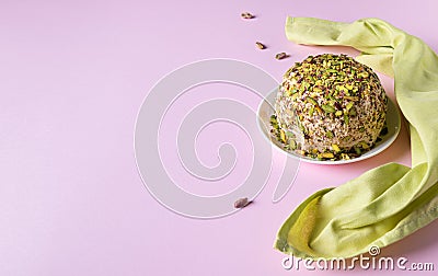 Halva with pistachios nuts and napkin on pink background Stock Photo