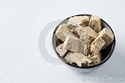 Halva slices in a bowl. Oriental sweetness. Copy space. Stock Photo