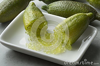 Halved fresh raw green finger lime caviar with sour pearls Stock Photo