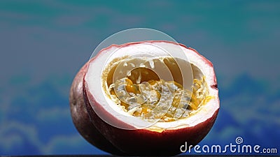 Close up of fresh passion fruit, bursting with sky-blue background. Comestible. Stock Photo