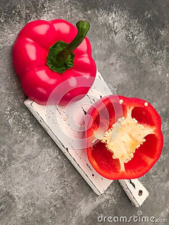 Halved red bell pepper on a cutting board Stock Photo