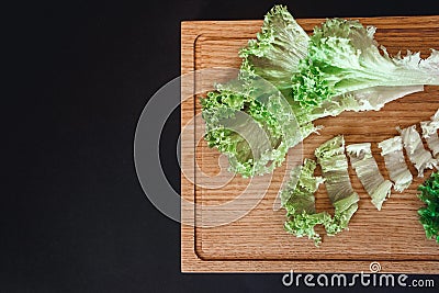 Halves of fresh cabbage on old brown wooden table on black background with copy space. Top view Stock Photo