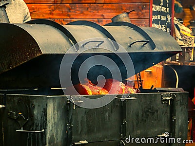 Ham being cooked in iron oven Stock Photo