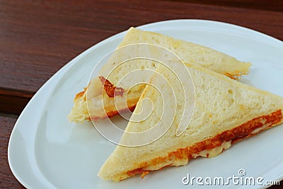 Ham and cheese sandwich on a white plate. Stock Photo
