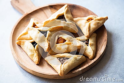 Hamantashen cookies on a wooden board on a gray background. Close up Stock Photo