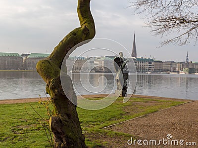 View at tree and sculpture named Windsbraut, whirlwind and Binnenalster in Hamburg, Germany. Editorial Stock Photo