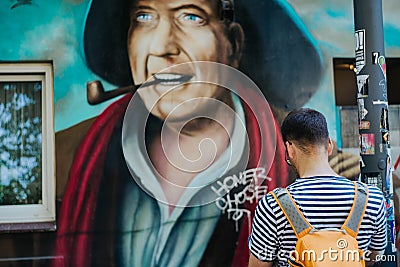 HAMBURG, GERMANY - JUNE 8, 2016: traveler in front of hans albers graffiti wall Editorial Stock Photo