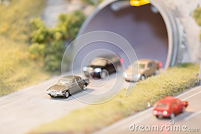 Cars, with lights on, entering and leaving a tunnel Editorial Stock Photo