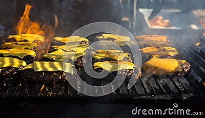 Hamburger being grilled over a wood fire Stock Photo