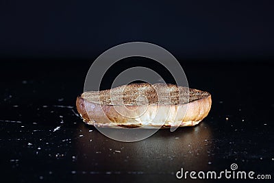 Burger bun on a black background. Lower half burger bun Stock Photo