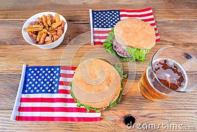 Hamburgers, beer, potatoes, and U.S. flags on a wooden base. Concept 4th of July, Independence Day Stock Photo