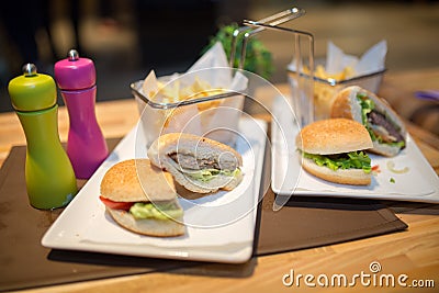 Hamburgers served with fries.Colorful.Hamburger with beef meet, vegetables, ketchup and chips on plate.Unhealthy,fatty food Stock Photo