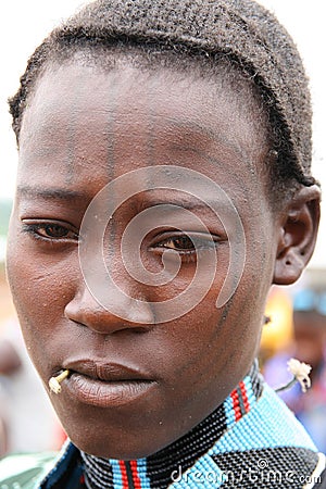Hamer girl with a toothstick and tattoo, Ethiopia Editorial Stock Photo