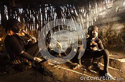 Hamer woman cooking in her hut Editorial Stock Photo