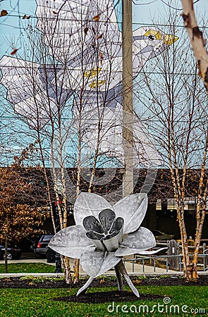 Hamilton, Ohio urban park with metal flower sculpture and flying bird mural. Editorial Stock Photo