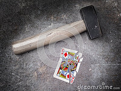 Hammer with a broken card, king of diamonds Stock Photo