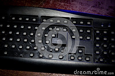 Hammer on computer keyboard with damaged keys Stock Photo