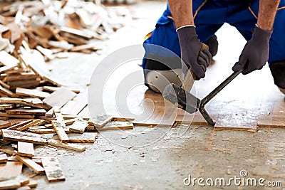 Hammer, crowbar and a pile of old flooring Stock Photo
