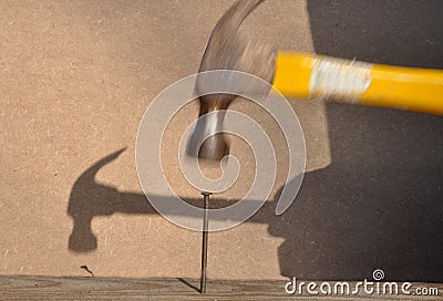 Hammer hitting nail Stock Photo