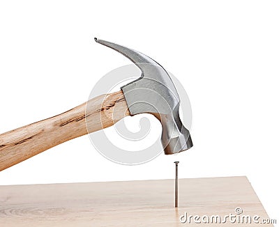 Hammer hitting a nail into a wood Stock Photo