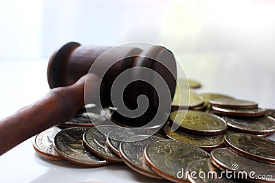 Hammer of a judge on a heap of dolor coins Stock Photo