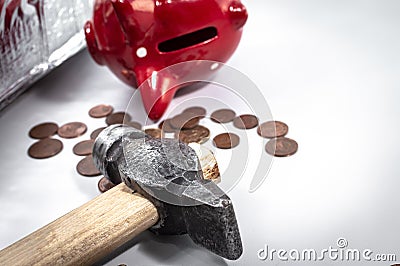 The hammer lies next to a red piggy bank and a bunch of small euro coins. Concept of finding money, shopping, crisis, poverty, Stock Photo