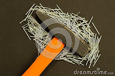 Hammer with nails isolated on black background Stock Photo