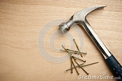 Hammer and nails on wood plank Stock Photo