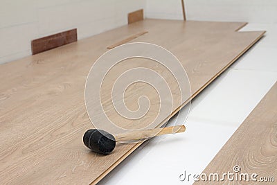 Hammer on New Laminate Floor Stock Photo