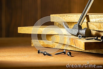 Hammer and screw on lumber in lighting and shadow of the sunshine in morning. Stock Photo