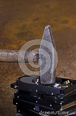 Hammer on stack of hard disk Stock Photo