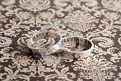 Hammered Rings on Brown Desiger Background Stock Photo