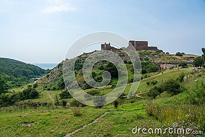 Hammershus, Bornholm / Denmark - July 29 2019: Grassy hills infornt of old fortification on the Dansigh island of Bornholm with Editorial Stock Photo