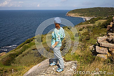 Hammershus - Bornholm, ruins of an old castle, Female tourist admiring the beautiful landscape. Editorial Stock Photo
