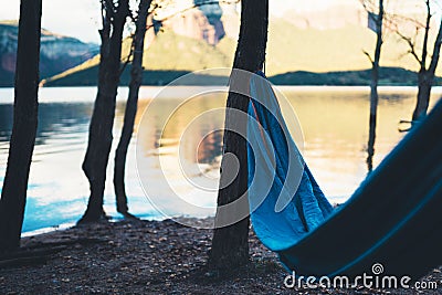 Hammock for relax on background of nature lake, chilling outdoor, traveler recreation mountain landscape; camping lifestyle; enjoy Stock Photo
