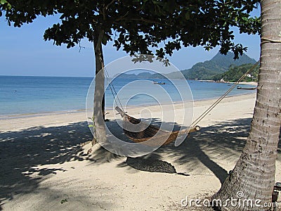 Hammock on white sandy beach Stock Photo