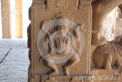 Hampi Vittala Temple Male deity in dance pose holding a snake Naga in the right hand pillar carving Stock Photo