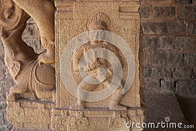 Hampi Vittala Temple pillar carving of a man or demon holding a horn Stock Photo